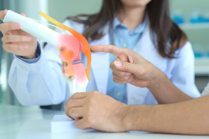 Man At Podiatrist S Appointment Touches A Knee Prototype