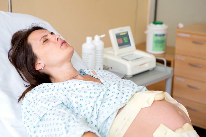 Pregnant Woman In Delivery Room Having Contractions