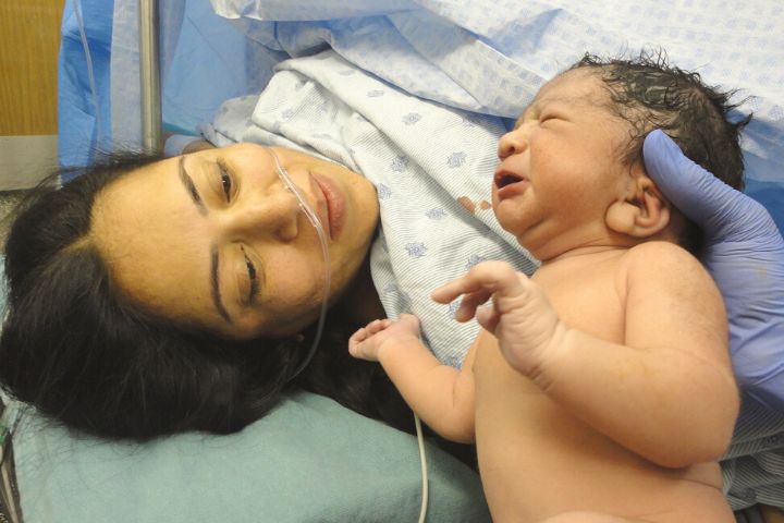 Woman Who Has Given Birth Is Shown Her Child