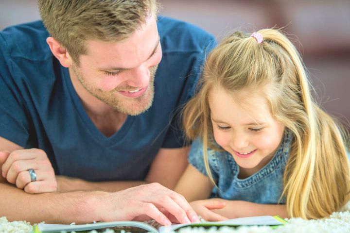 Father Reads Aloud To His Daughter