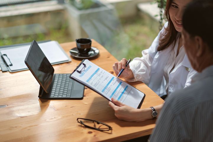 Woman Selects A Company For Health Insurance