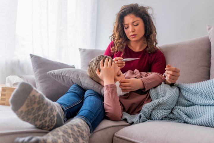 Mom Is Sitting With A Child With A Fever